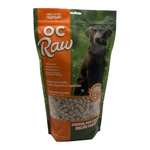 A bag of OC Raw freeze dried dog treats for dogs, featuring a dark brown dog on the front of the packaging, with an orange and green design.