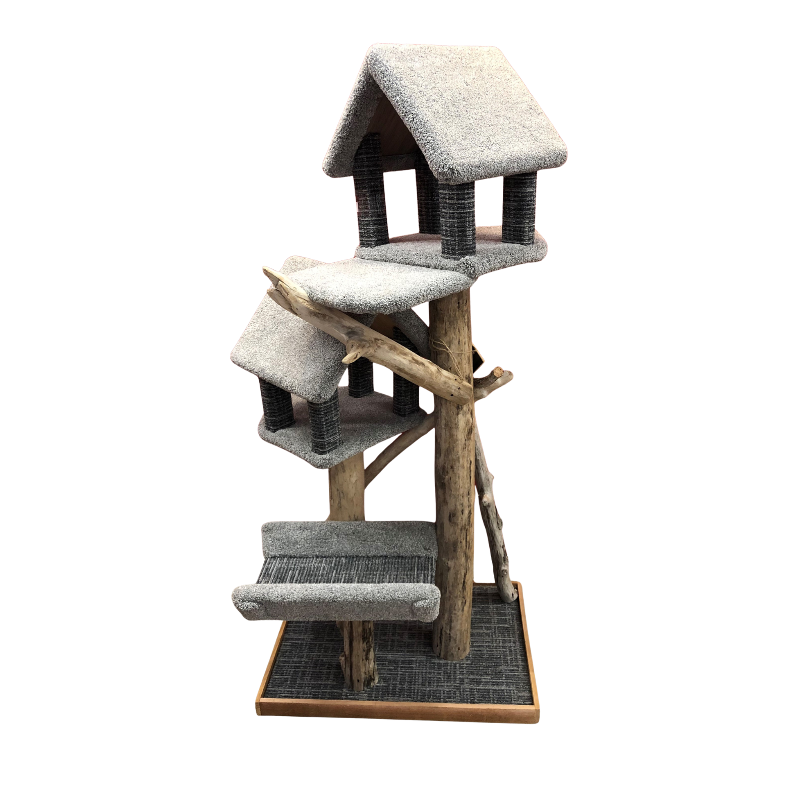 A multi-level cat tree with a rustic design, featuring a central wooden post, three tiers of gray carpeted platforms, two small house-shaped perches with dark wrapped claws, and a natural driftwood branch accent, all set on a square wooden base against a white background.