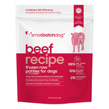 A stand-up pouch of Small Batch Dog 'Beef Recipe' frozen raw patties for dogs, featuring a white top half and a deep red bottom half with pink text and graphics.