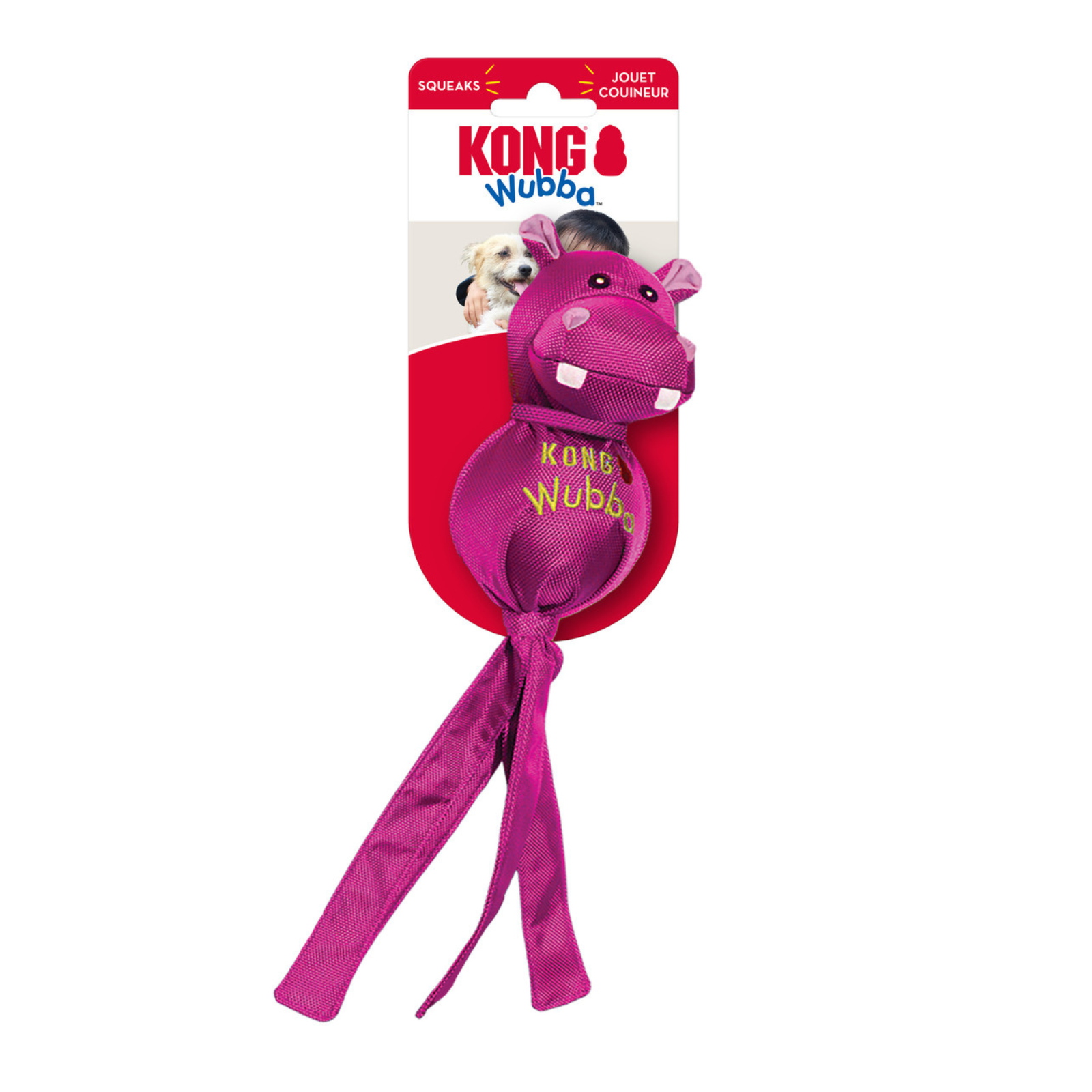 Kong Wubba dog toy in pink, featuring a hippo-shaped plush head with white teeth and a long pink ribbon tail, attached to a red and white cardboard backing card with the KONG brand logo.