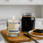 Pet House Candle with a jar of jelly and toast on a wooden cutting board.