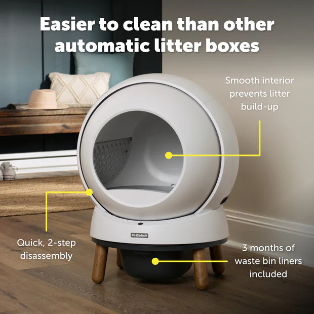 Automatic litter box with features highlighted on a wooden floor.