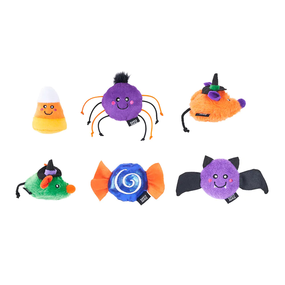 Set of colorful Halloween-themed plush toys on a white background
