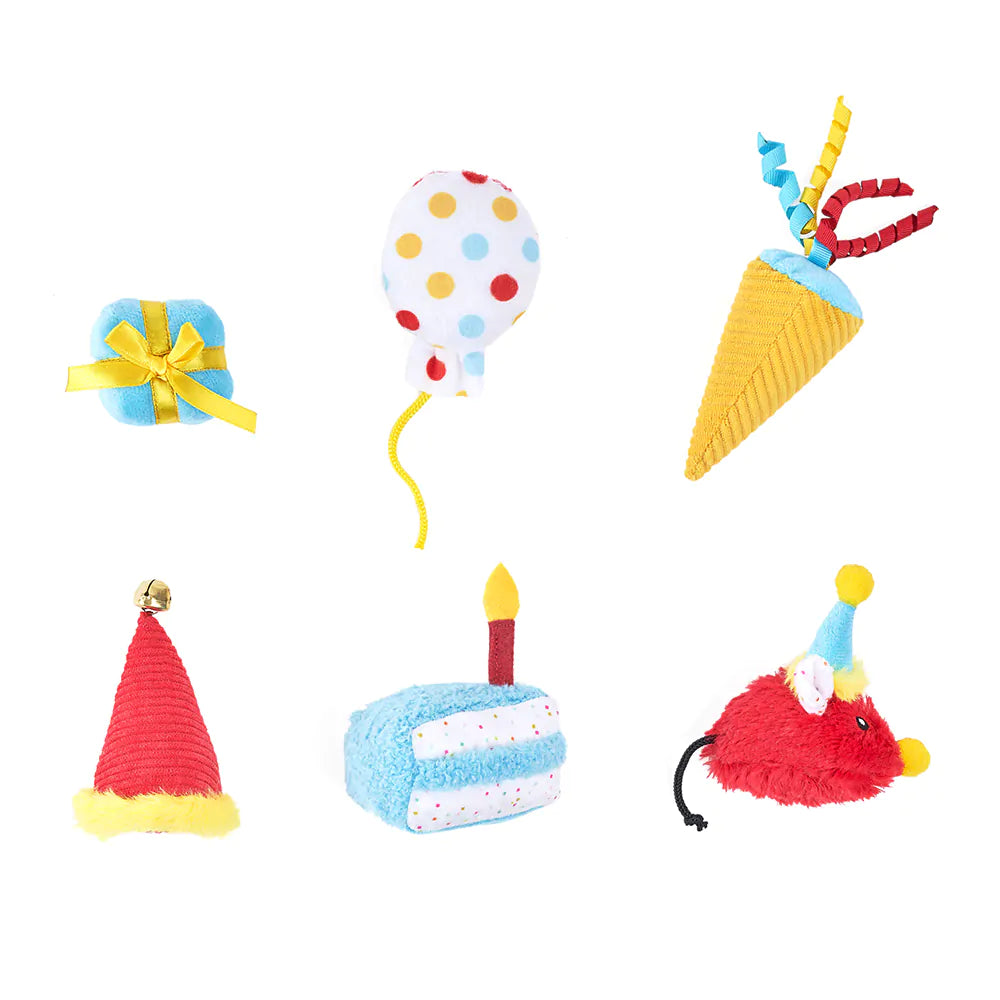 Set of colorful toy items including a balloon, gift, cake, and party hats on a white background