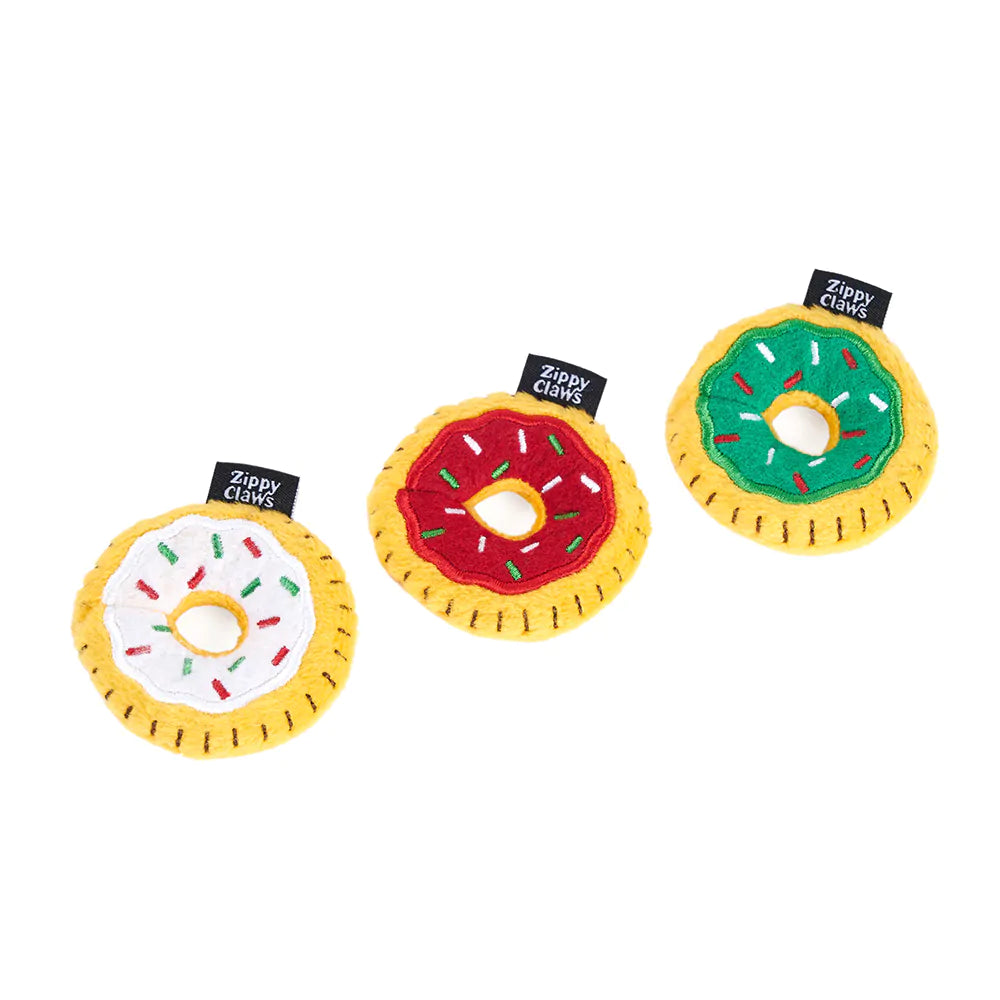 Three donut-shaped dog toys with colorful icing and Zippy Claws branding on a white background.