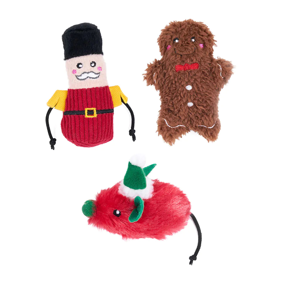 Three Christmas-themed dog toys on a white background