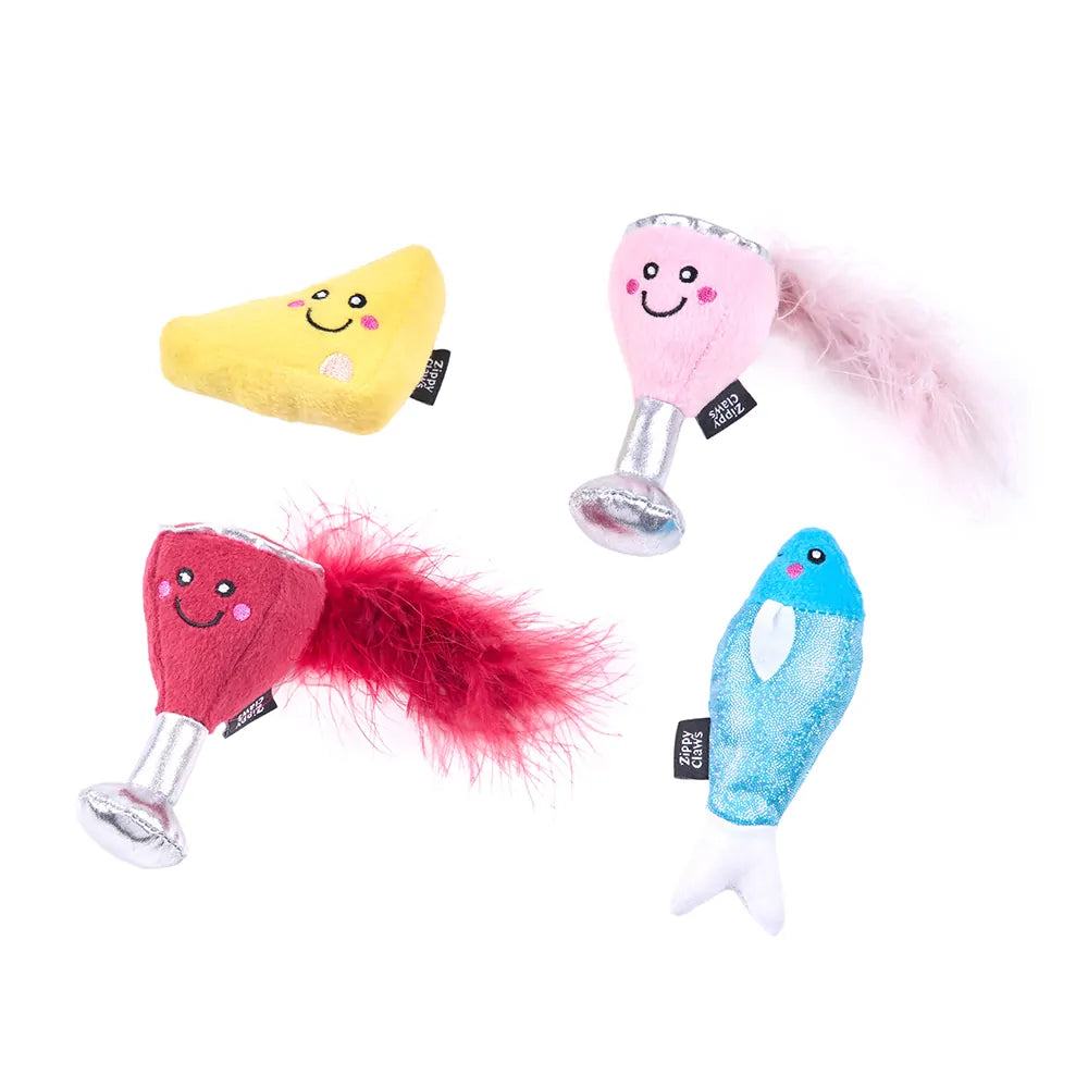 Four colorful dog toys with smiling faces on a white background