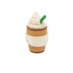 Toy resembling a coffee cup with whipped cream and a green straw on a white background
