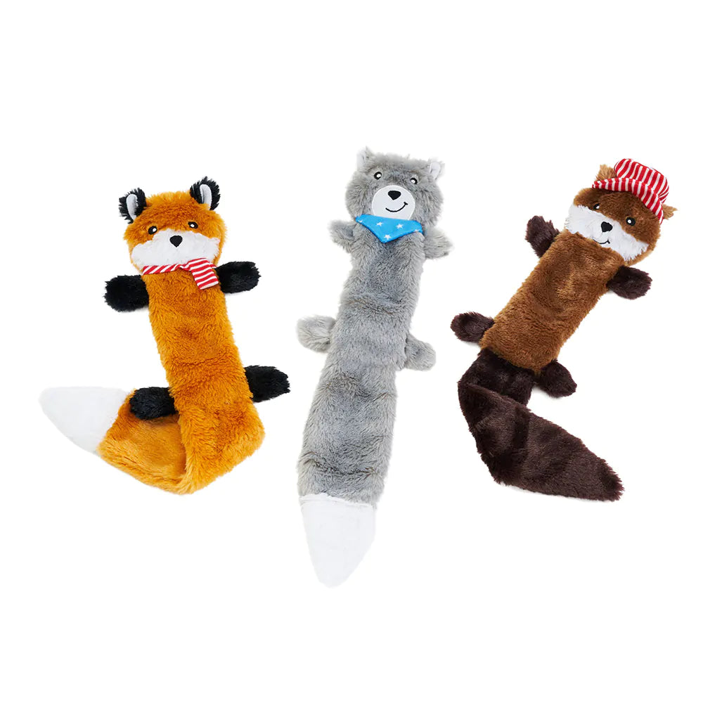 Three plush dog toys shaped like a fox, wolf, and raccoon on a white background