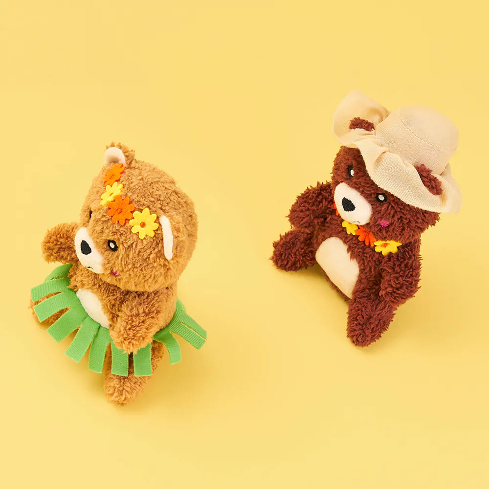 Two plush toys resembling bears on a yellow background