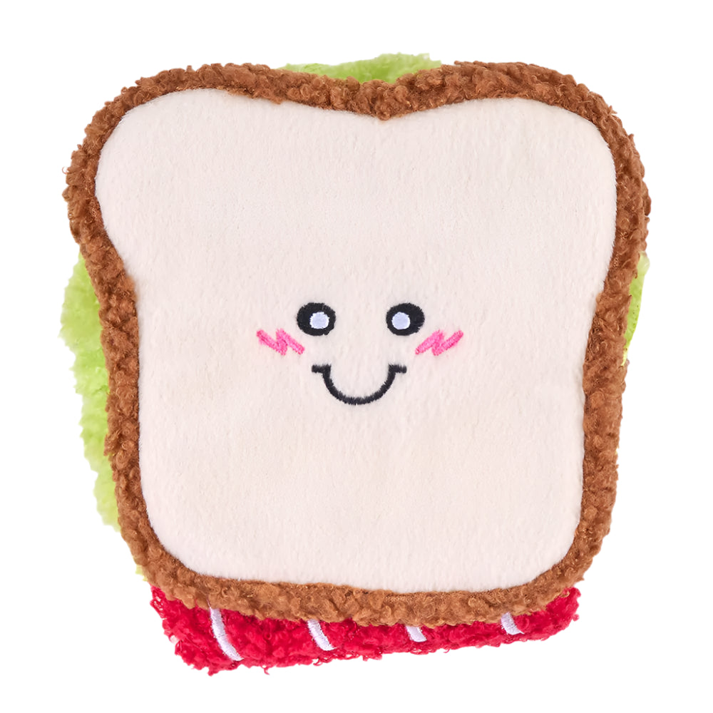 Toy resembling a sandwich with a smiling face on a white background