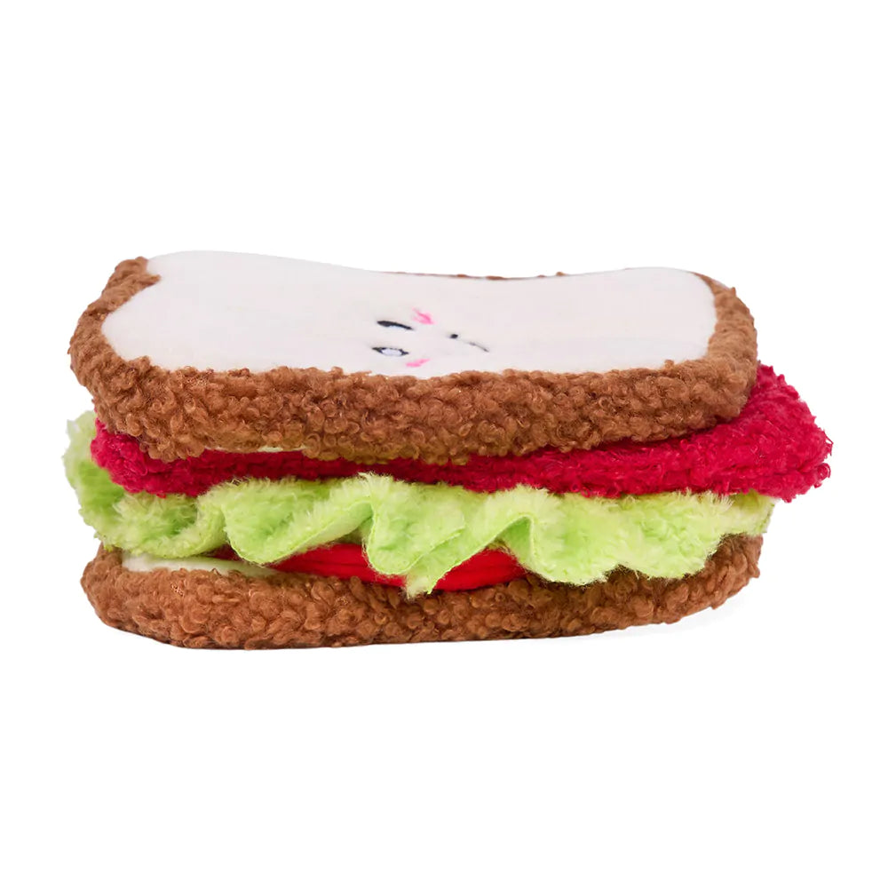 Plush toy designed like a sandwich with brown bread, white cheese, red meat, and green lettuce on a white background.