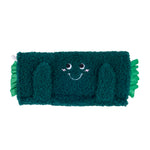 Green plush toy with a smiling face on a white background
