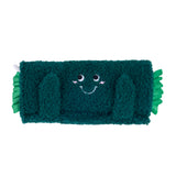 Green plush toy with a smiling face on a white background