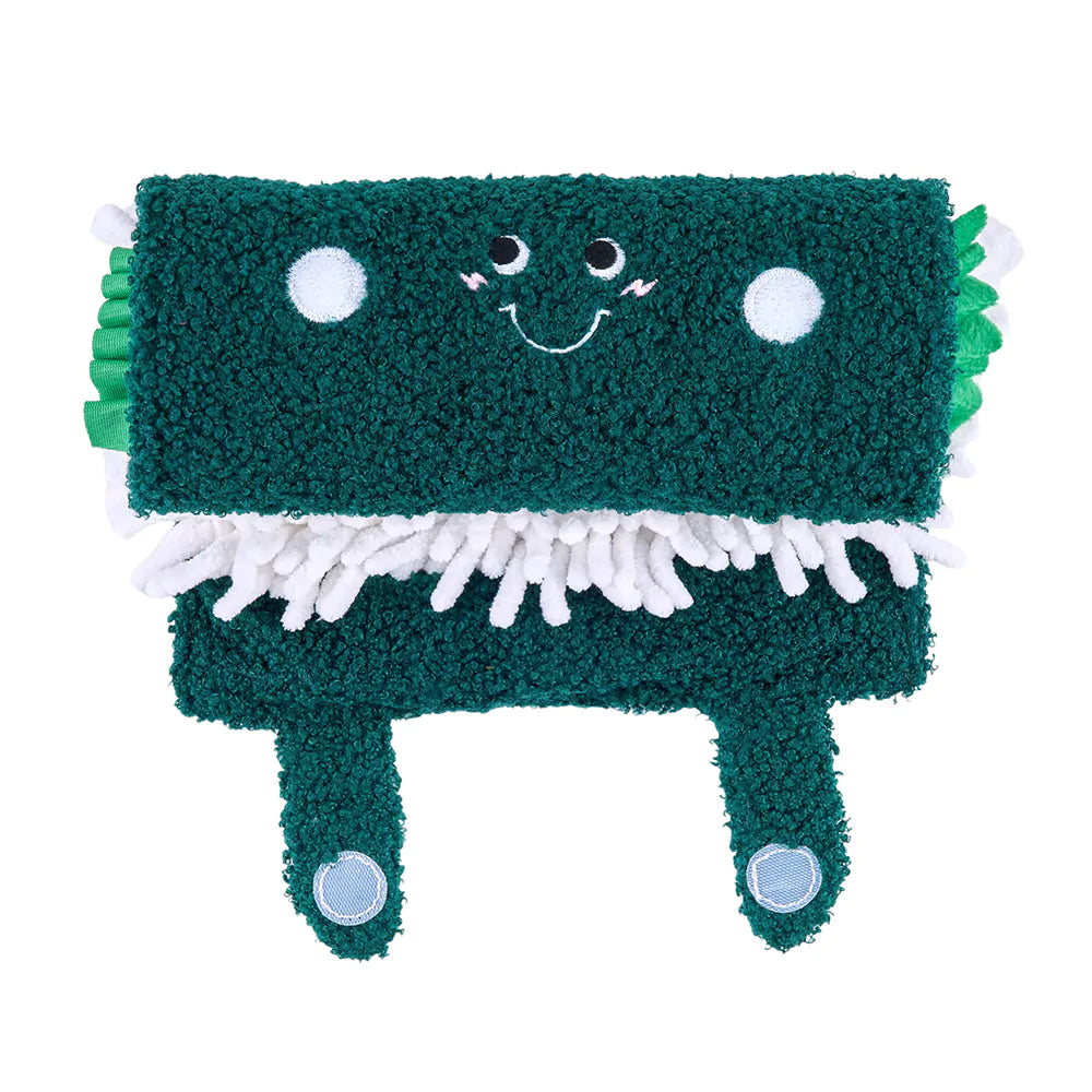 Green plush toy with a smiling face on a white background