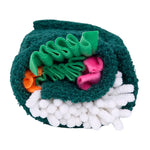 Toy resembling a roll of sushi with green, pink, orange, and white colors on a white background