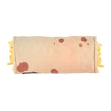 Folded blanket with brown spots and yellow edges on a white background