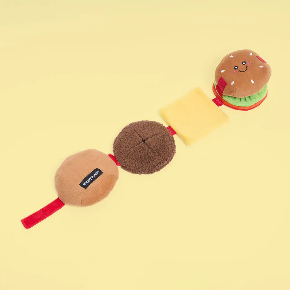 Plush toy resembling a hamburger on a yellow background