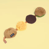 Set of four plush toys shaped like a hamburger, bun, and two different items on a yellow background.