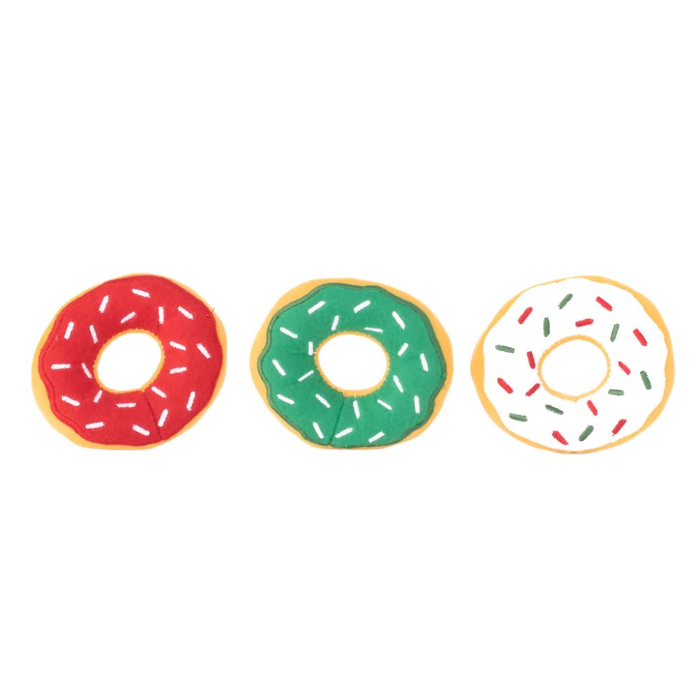 Three colorful donut-shaped cookies with sprinkles on a white background