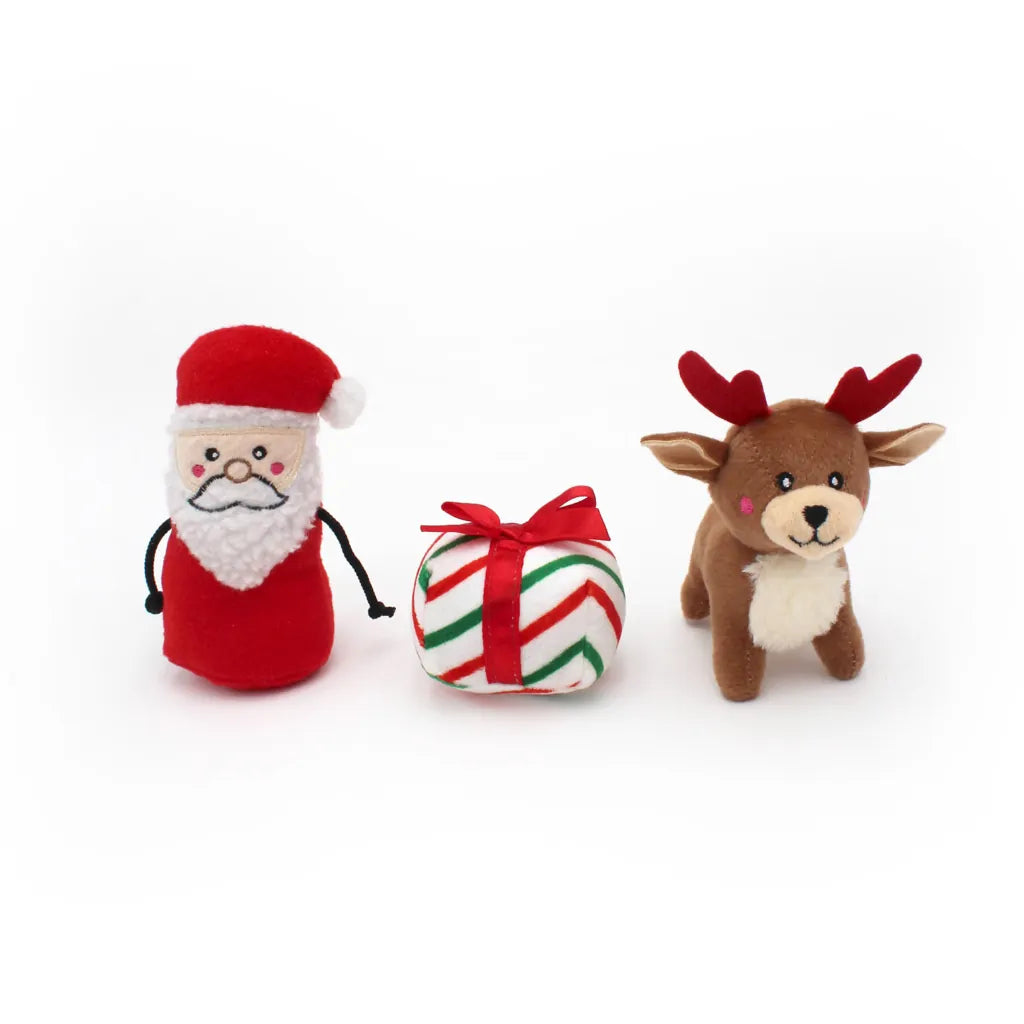 Plush toys resembling Santa Claus and a reindeer with a candy cane-shaped gift on a white background