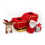 Red toy truck with Santa Claus figure, reindeer, and candy cane on a white background