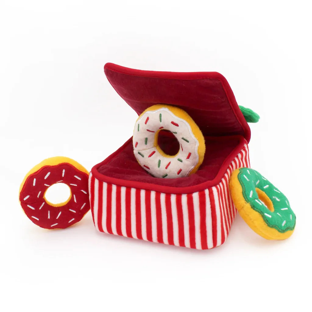 Plush toy resembling a box of donuts with red and white striped design on a white background