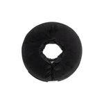 Black donut-shaped pillow on a white background