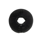 Black donut-shaped pillow on a white background