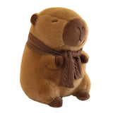 Plush groundhog toy with a brown scarf on a white surface.
