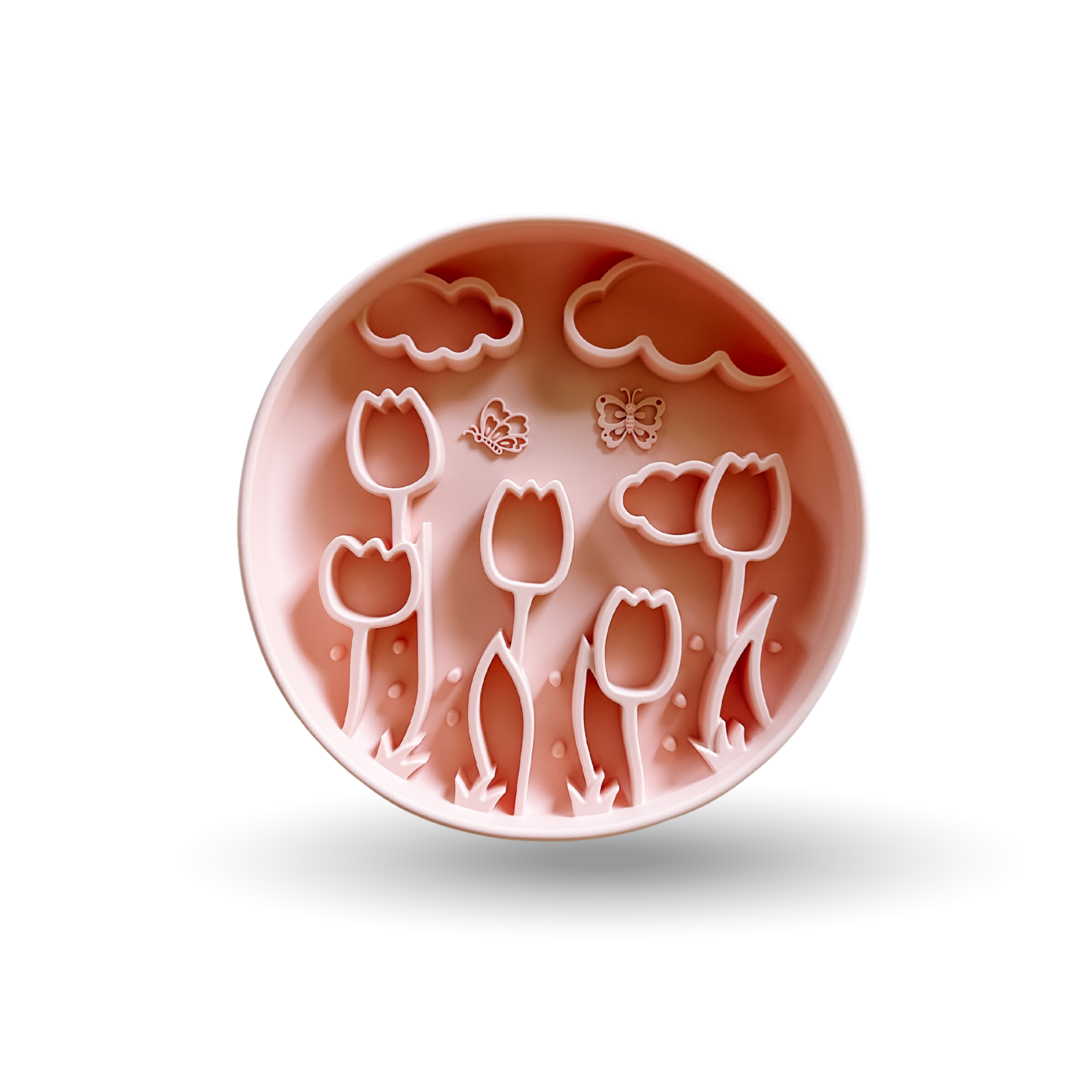 A round pink silicone mold with embossed tulips, clouds, and butterflies, shown on a white background with a soft shadow.