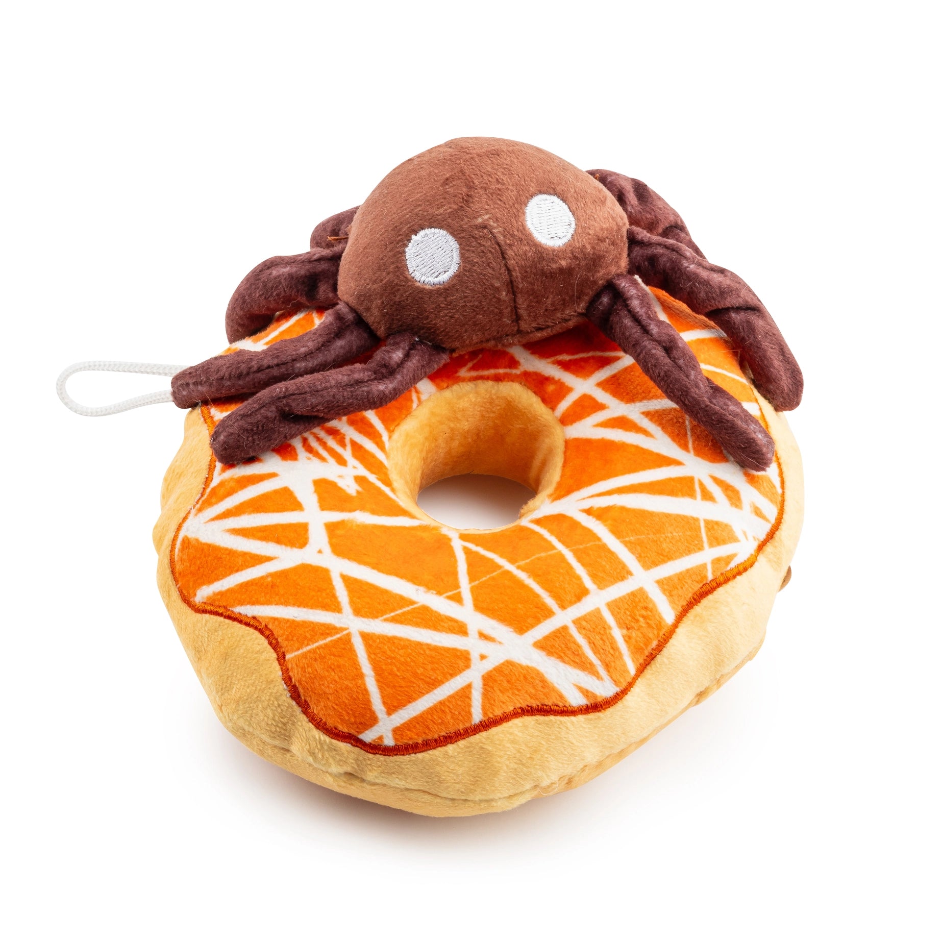 Plush toy resembling a spider on a donut with a white background