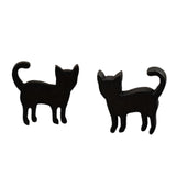 Black cat-shaped earrings on a wooden surface