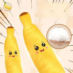 Plush banana toy with a happy face on a beige background