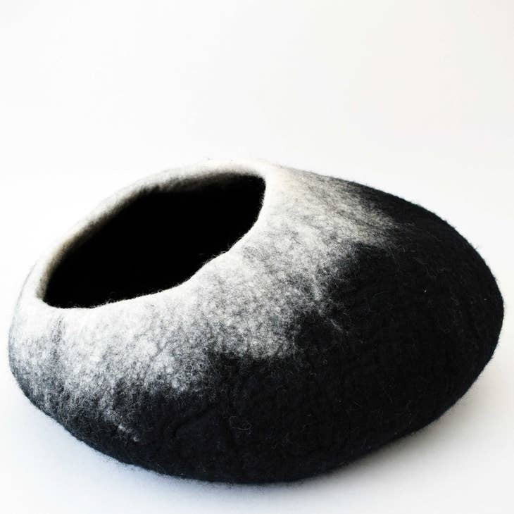 A black felt pet house with a white gradient fade on the exterior, photographed on a clean white background.