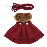 Red dog coat with fur collar and gold buttons, accompanied by a red leash on a white background