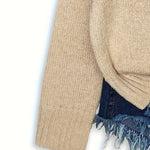 Beige sweater with denim fringe on a white background