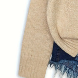 Beige sweater with denim fringe on a white background