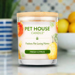 Pet House Candle labeled 'Fresh Citrus' on a surface with a blurred background