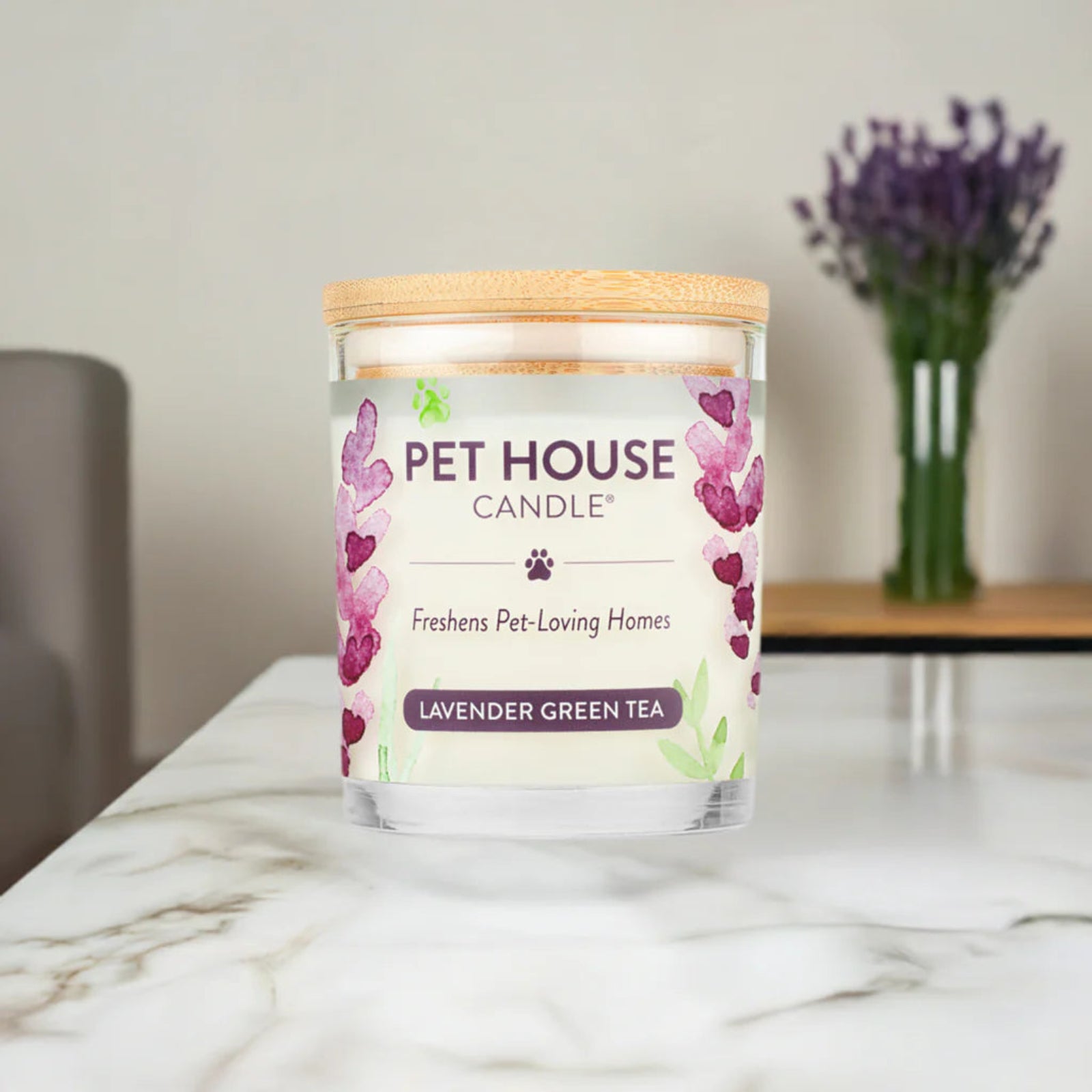 Pet House Candle labeled 'Lavender Green Tea' on a marble surface with a blurred background