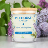 Pet House Candle labeled 'Lilac Garden' with a floral design on a blurred background of green and purple flowers.