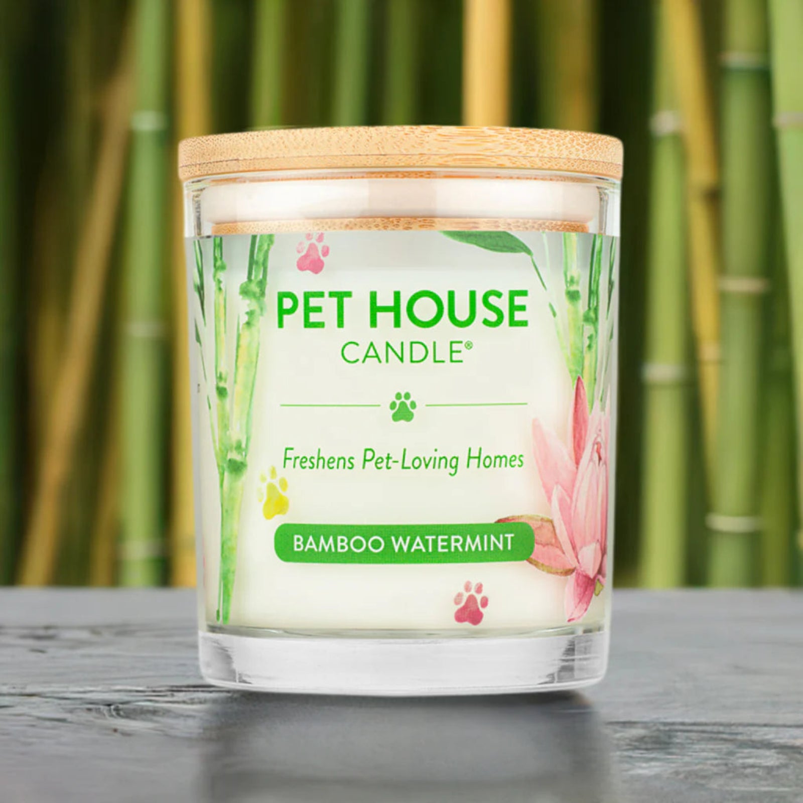 Pet House Candle with bamboo watermint scent on a wooden surface with a bamboo background