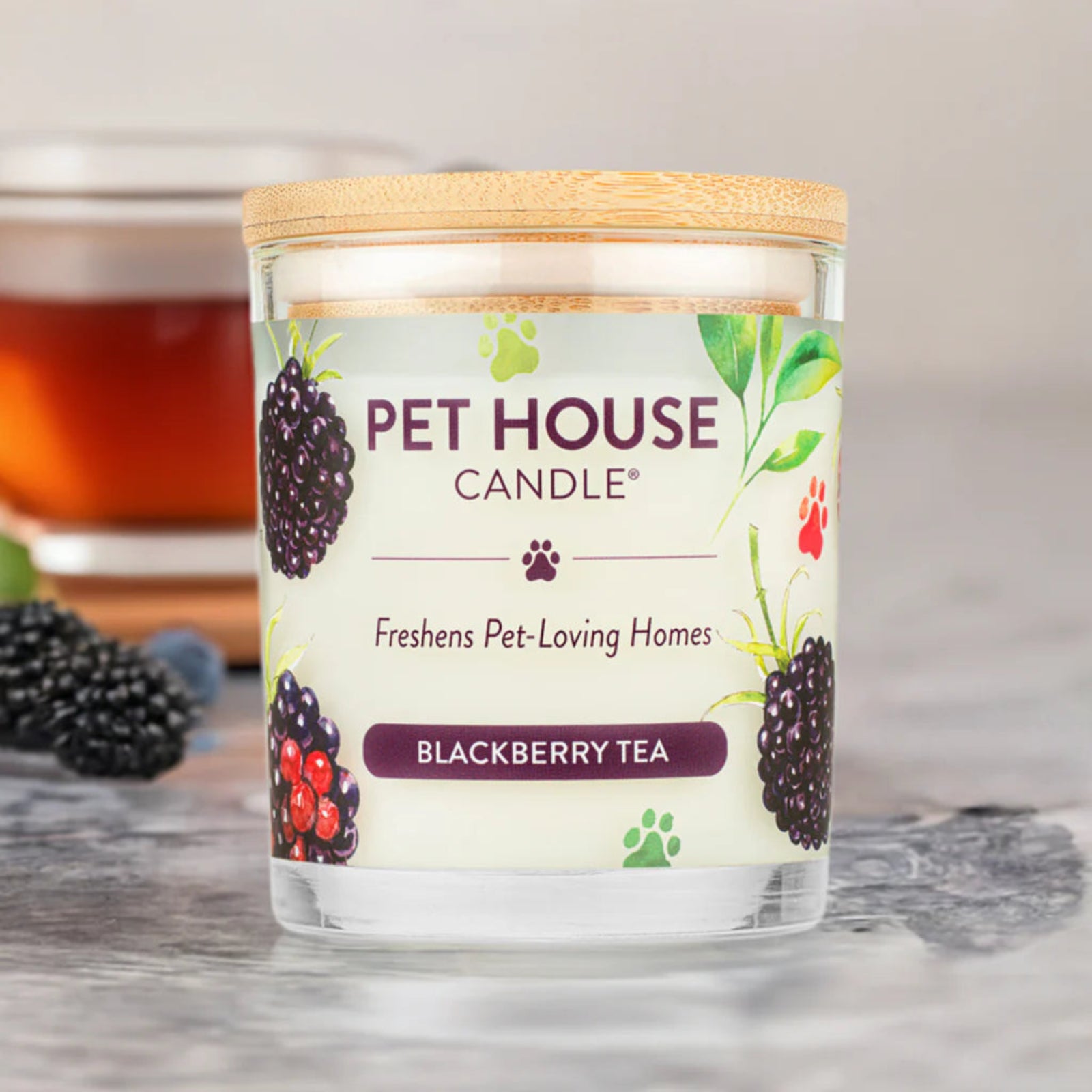 Pet House Candle labeled 'Blackberry Tea' on a wooden surface with a blurred background