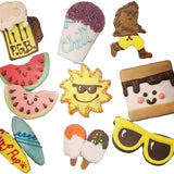 A collection of decorated sugar cookies shaped like a beer mug, an ice cream cone, a running character, watermelon slices, a sun with sunglasses, a marshmallow with chocolate drizzle, a surfboard with 'Sun Pop!' text, a blue surfboard, and yellow sunglasses, arranged on a light pink background.