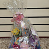A Prefilled Easter Basket for small to medium dogs, containing various toys and treats, wrapped in clear plastic with a ribbon.