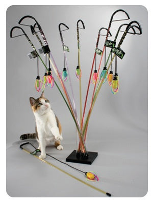 Cat playing with a colorful cat toy stand on a gray background