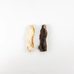 Two small fur paws, one light cream and one dark brown, displayed side-by-side on a plain white background.