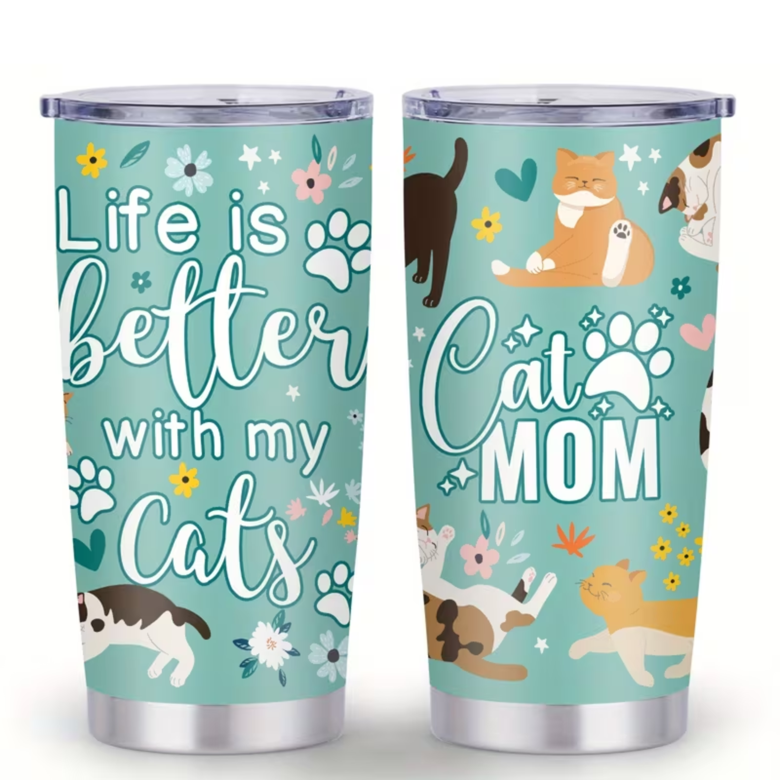 Two stainless steel travel tumblers with clear lids, featuring a light teal design with the phrase 'Life is better with my Cats' and 'Cat MOM' in white script, decorated with cartoon cats, paw prints, flowers, and hearts.