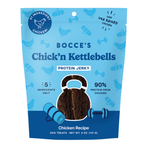 Bocce's Chick 'n Kettlebells Protein Jerky dog treats in a 5 oz resealable pouch. The packaging is light blue with dark blue graphics and text, featuring a clear window showing the dark brown jerky inside.