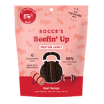Bocce's Beefin' Up Protein Jerky dog treats in a pink and red stand-up pouch, featuring a clear window showing the beef jerky inside.